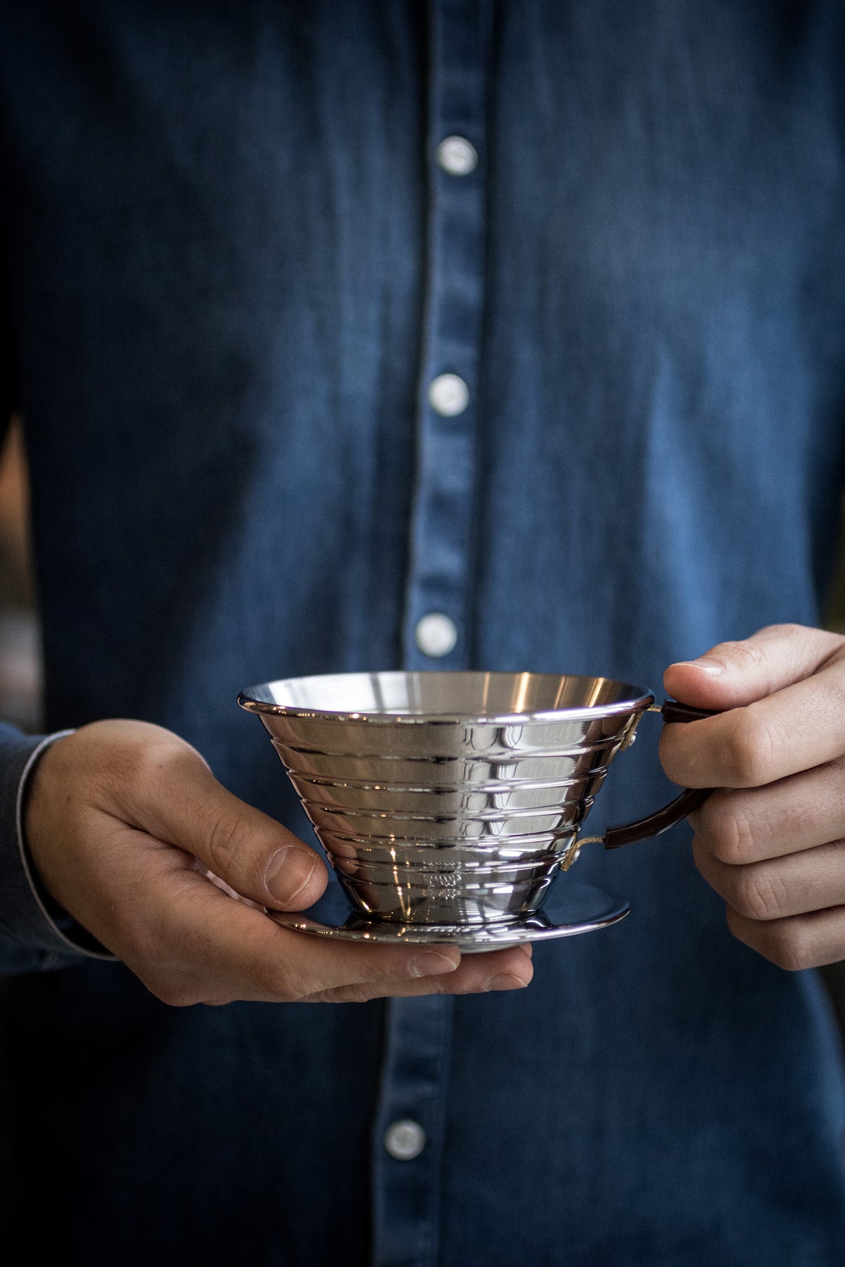 Hands holding a Kalita Wave dripper