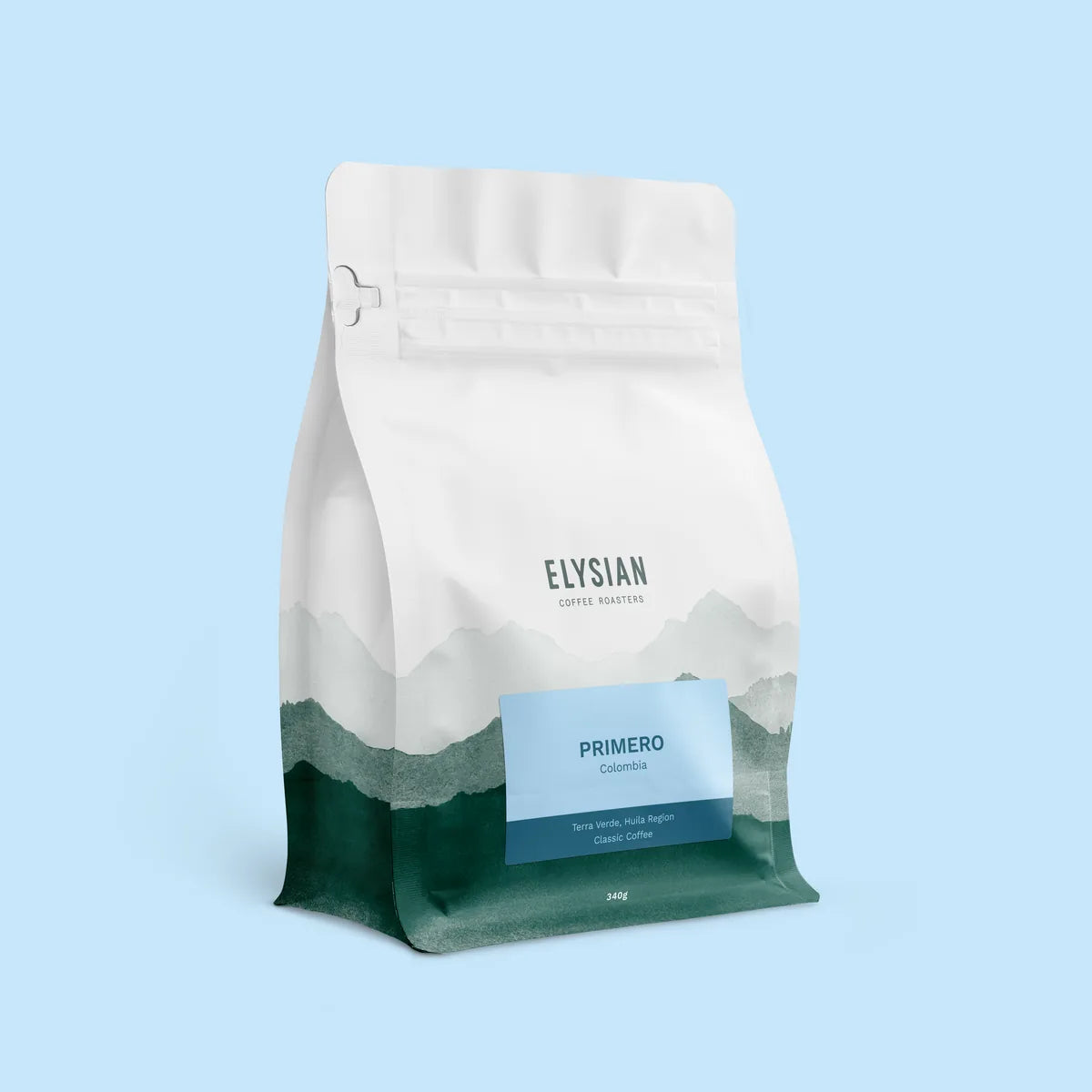 Primero filter coffee bag, white with painted green mountains, on a light blue background